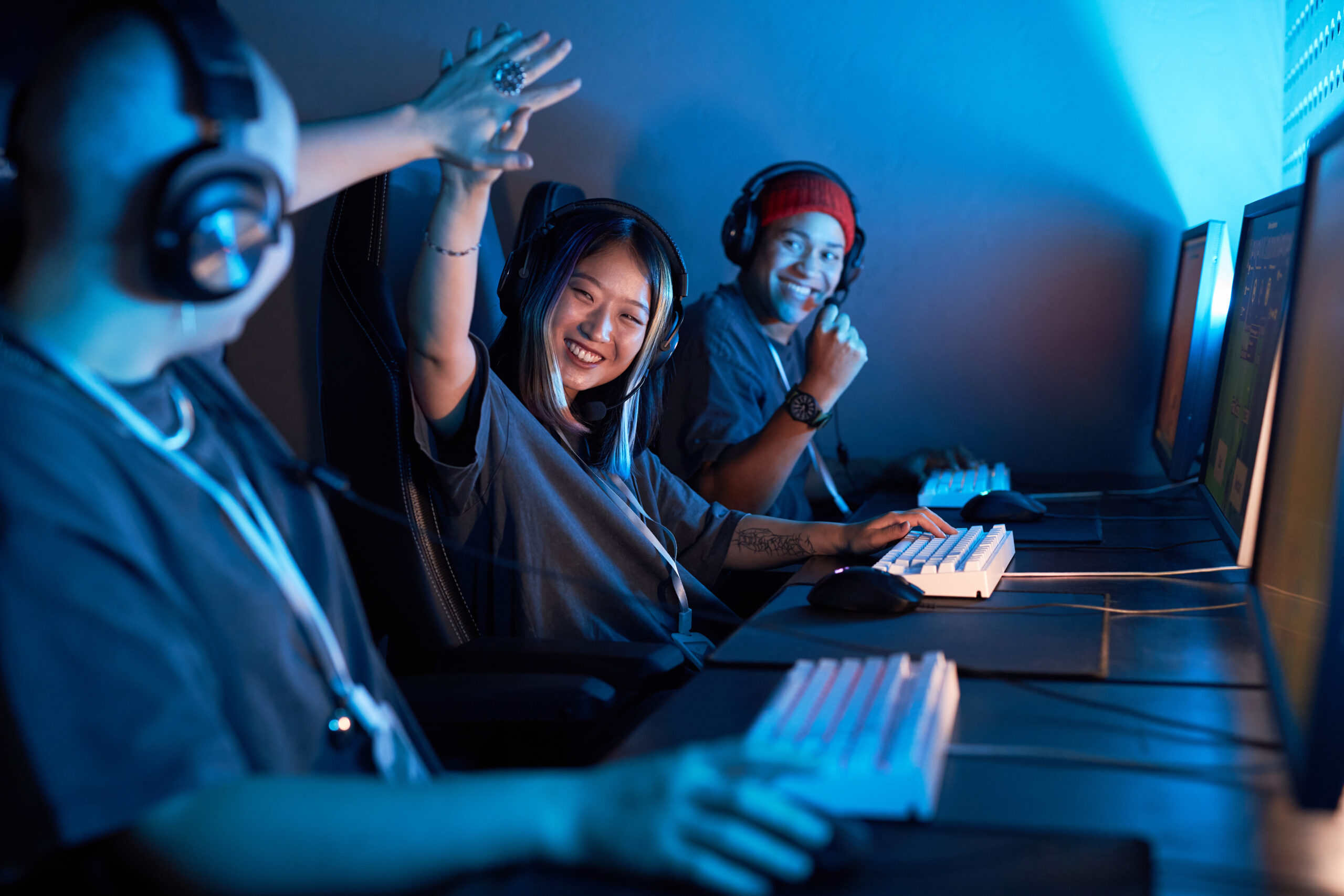 Asian female gamer high five teammate